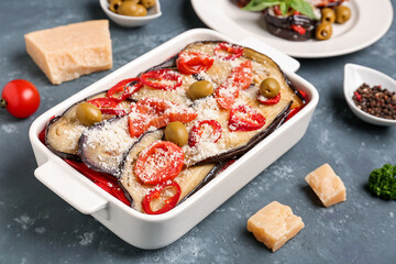 Baking dish with tasty baked Eggplant Parmesan on blue background