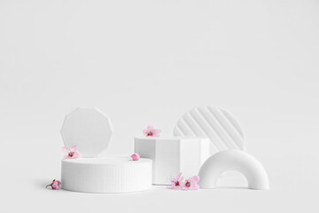 Decorative podiums and flowers on white background