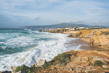 Coastline with atlantic ocean in Cascais, Portugal. Waves at the shore and rocky hills