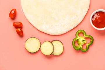 Raw dough and ingredients for preparing vegetable pie on pink background