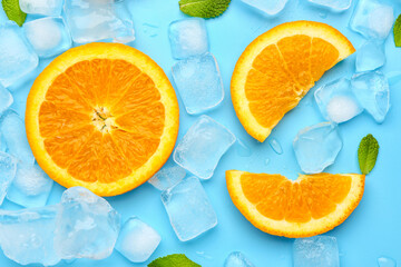 Sliced fresh orange with mint and ice on blue background