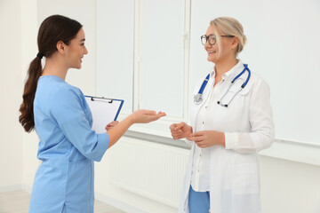 Medical doctors in uniforms having discussion indoors