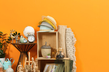 Many different items near orange wall. Garage sale