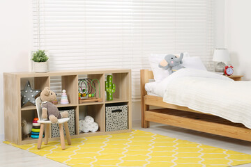Stylish children room with comfortable bed and toys. Interior design