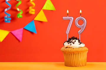 Birthday cake with number 79 candle - Sparkling orange background with bunting