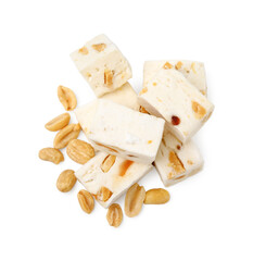Pieces of delicious nougat and nuts on white background, top view