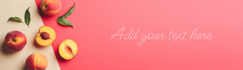 Fresh ripe peaches with green leaves on beige and coral background, flat lay. Add your text to this...