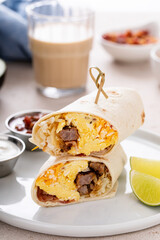 Breakfast burritos with scrambled eggs, sausage, cheese and potatoes