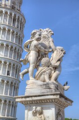 Fototapeta na wymiar Statue and Leaning Tower of Pisa