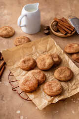 Fototapeta na wymiar Cinnamon cookies on a parchment paper with milk