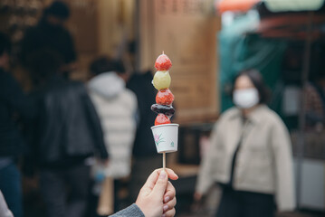 Candy fruit stick with blur market background 