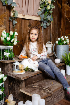 Kid Feeding And Petting Rabbit During Spring Time. Children Play With Real Rabbit. Laughing Child At Easter Egg Hunt With Pet Bunny. Little Toddler Girl Playing With Animal. Girl Feeding Generative AI