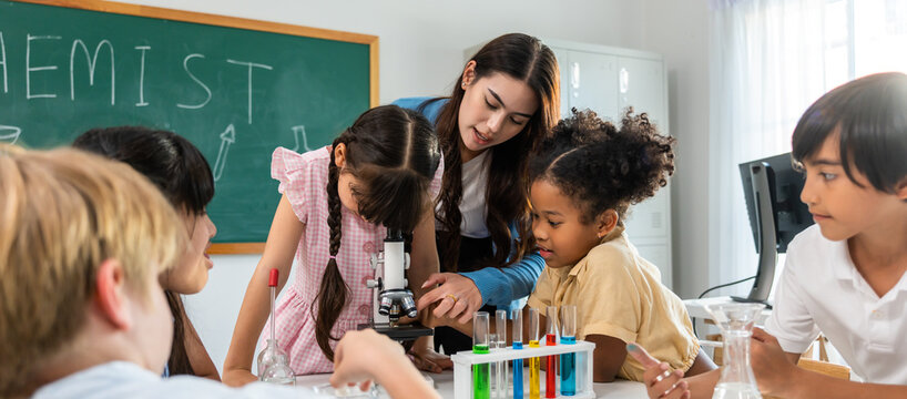 Group of student learn with teacher in classroom at elementary school. 