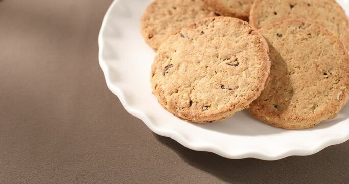 oatmeal cookies with milk close-up. whole grain product. healthy breakfast on a sunny morning. pastries on a brown table. sweets on a plate Generative AI