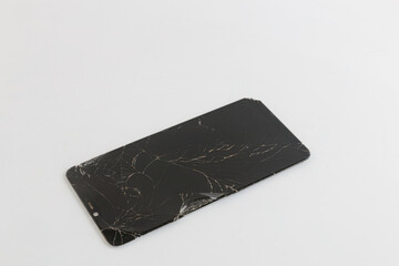 Broken old smartphone screen on white background