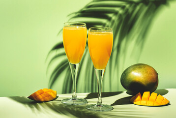 Mango bellini alcoholic cocktail with prosecco or sparkling wine, mango puree, syrup and ice. Light...