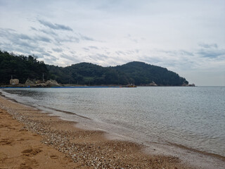 It is a beach with a mountain view.
