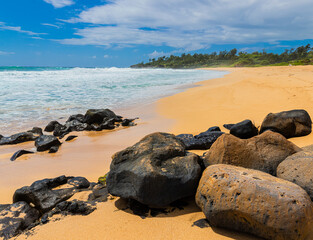 Waves Washing Over Lava Rocks on The Sandy Shore of Donkey Beach, Kauai, Hawaii, USA