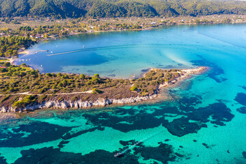 Seascape on a sunny day. Top view of a beautiful bay. Aegean sea texture in Vourvourou, Greece