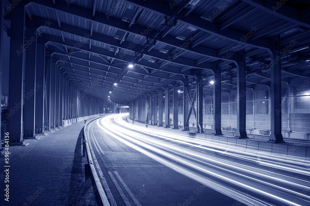 Poster light trails and head lights of traffic in tunnel