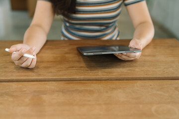 Woman holding a book device reading on e-book on digital tablet device or social media apps online ecommerce.