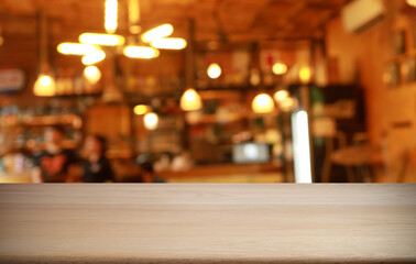 Empty wooden table in front of abstract blurred background of coffee shop . can be used for display or montage your products.Mock up for display of product