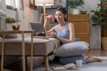 Women holding credit card and using laptop at home.Online shopping, internet banking, store online, payment, spending money, e-commerce payment at the store, credit card, concept