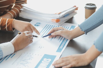 Brainstorming Collaboration and successful partnership analysis by Young business Asian people working in an office workspace