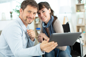 a couple at home using tablet