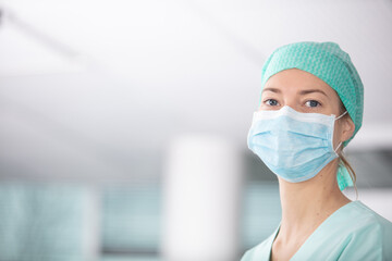 Fototapeta na wymiar headshot of female nurse wearing hairnet and face mask