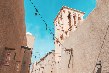 Al Fahidi district streets and traditional arab wind tower used for ventilation and air...