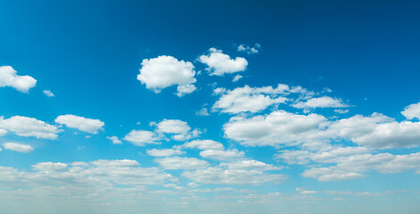 A clear blue sky with clouds and a white cloud in the sky.
