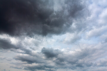 A stormy sky full of gray clouds . The sky before the rain.
