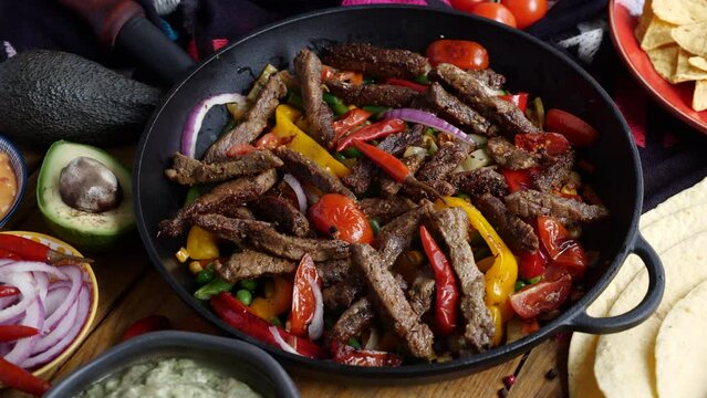 Fajitos fajita fajitas is a popular Mexican dish of meat and vegetables, cut into strips and grilled Generative AI