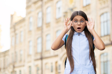 Fototapeta premium eyesight of amazed school girl with glasses. eyesight of school girl outdoor.