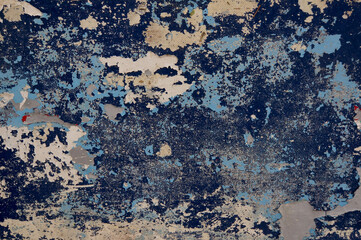 Old blue peeling paint on a wall, textured background