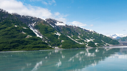 Naklejka na ściany i meble Hubbard Glacier nature in Alaska, USA. Attractive view at green mountain slopes