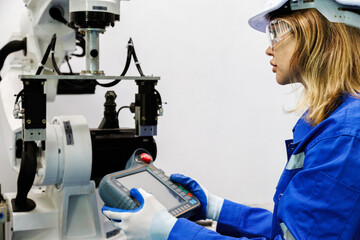female automation machine engineer student study and inspection control robot arm machine in...