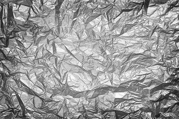 Crumpled silver paper texture background. Black and white tone.