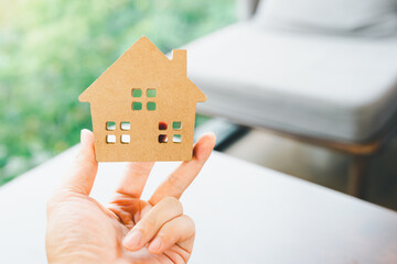 House model in home insurance broker agent ‘s hand or in salesman person. Real estate agent offer house, property insurance and security, affordable housing concepts.