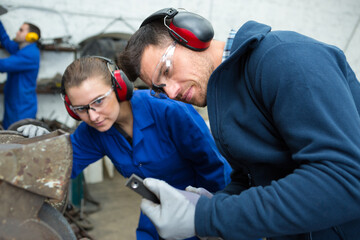 portrait of two workers in factory