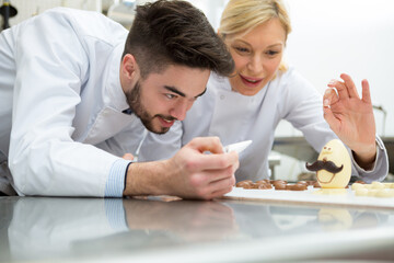 portrait of people making chocolate eggs