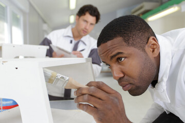 team of professional decorators painting indoors