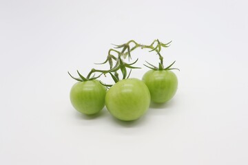 green tomato on white background