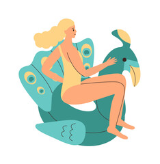 Girl in swimsuit is sitting on an inflatable circle in form of peacock. Colorful rubber inflatable swimming ring.