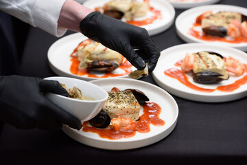 chef in the restaurant prepares saganaki, traditional Greek cheese snack that is fried in a pan or grilled