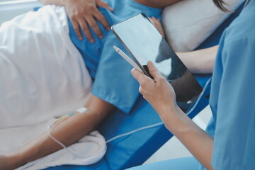 Injured patient showing doctor broken wrist and arm with bandage in hospital office or emergency...