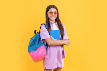 photo of teen school girl with backpack, education. teen school girl isolated on yellow.