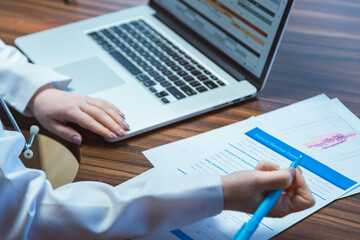 The doctor makes notes in the office after the shift, works late at the clinic. The therapist does paperwork at the end of the working day