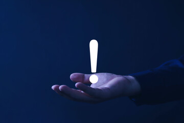Businessman hand showing white exclamation mark, business development concept error warning...